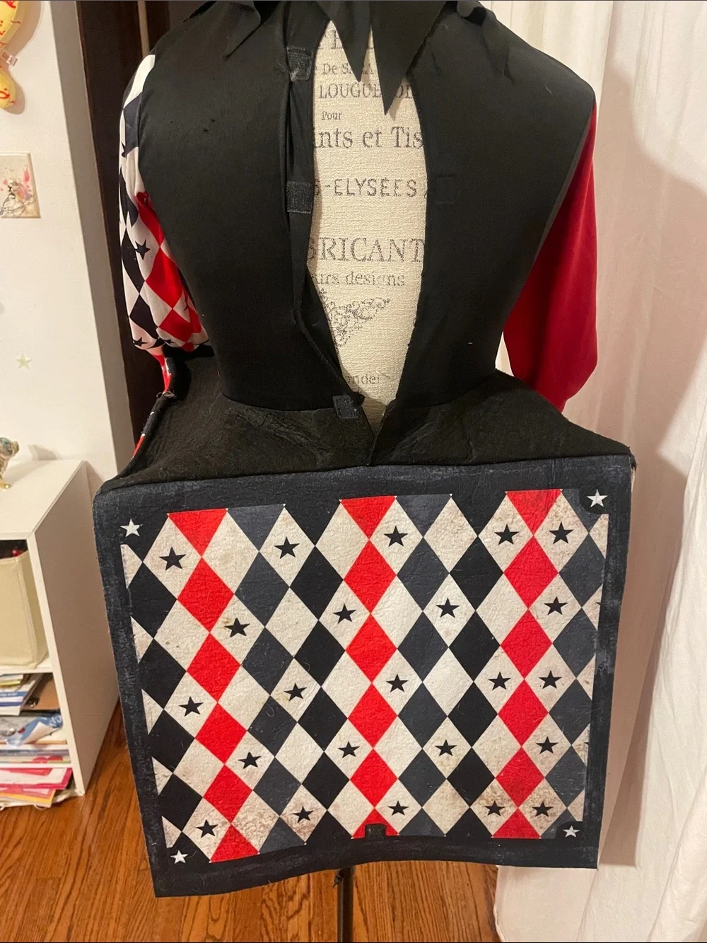 Dirty, scary Jack-in-box Halloween costume or cosplay, including jeweled mask.